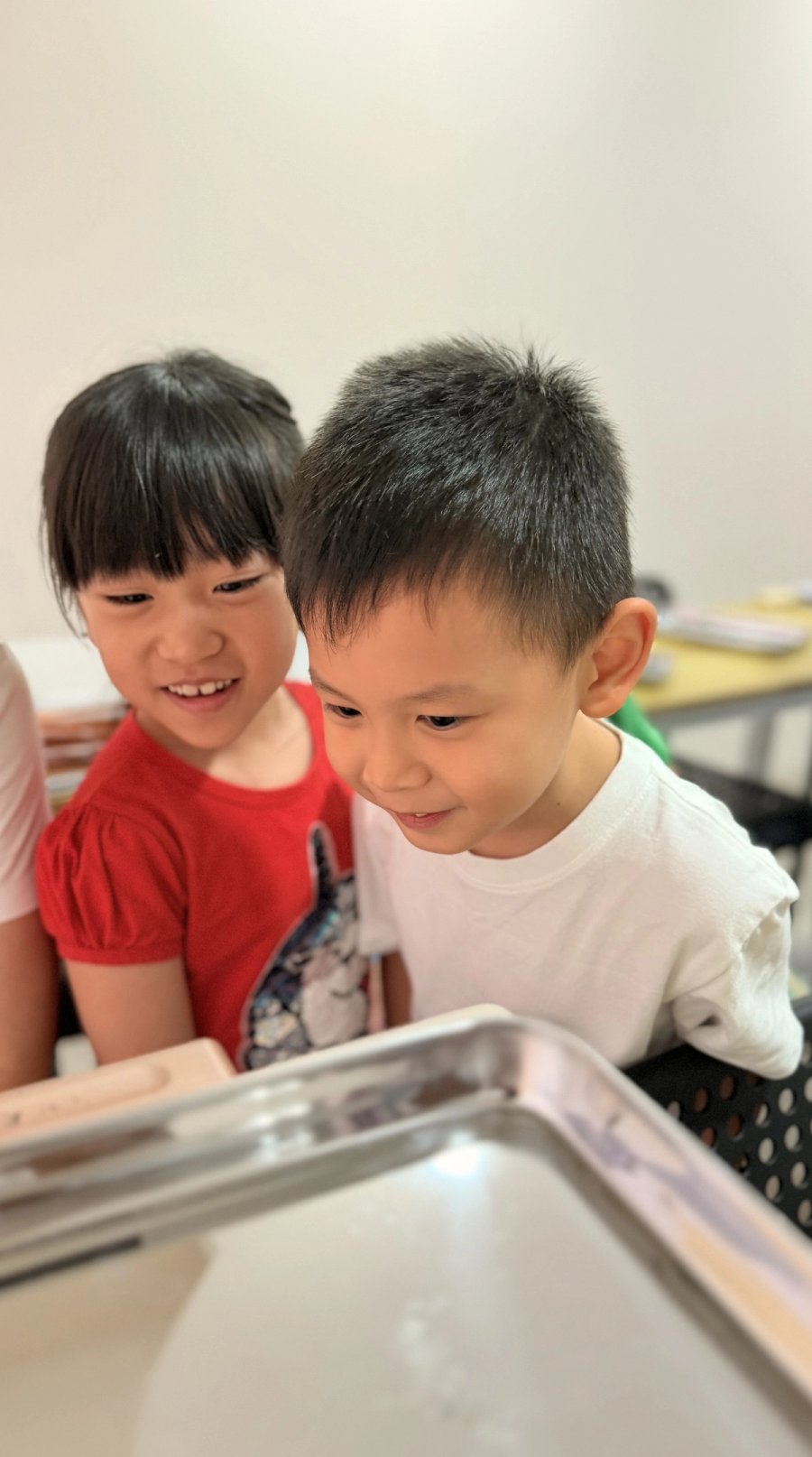 Two Pebbles students looking at something